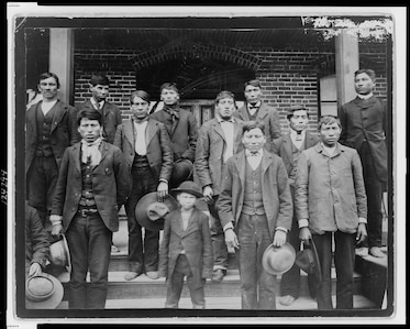 Native American boys posing outside the Carlisle Indian School