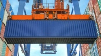 Cargo container hoisted midair by crane