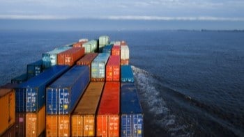 Overhead view of full container ship on water