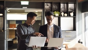 Men in office looking at computers