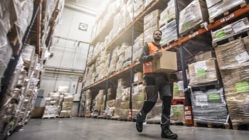 Man carrying box in warehouse