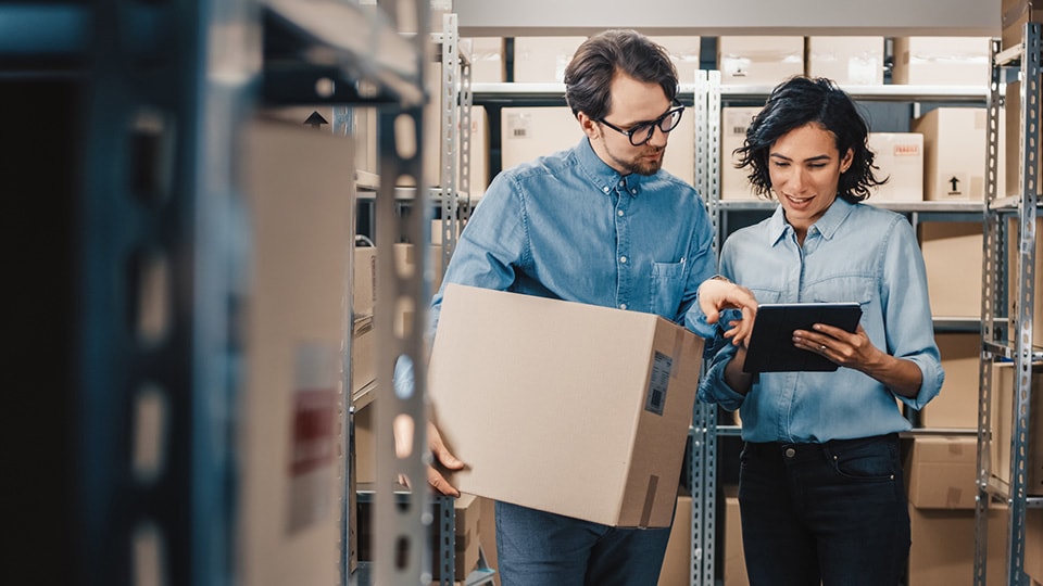 People in warehouse surrounded by boxes