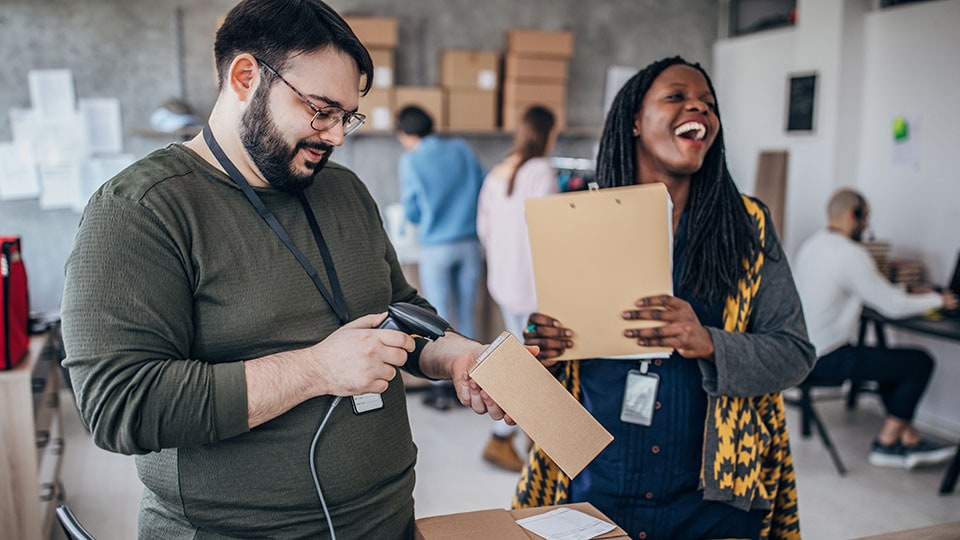 Two businesspeople handling customer orders.