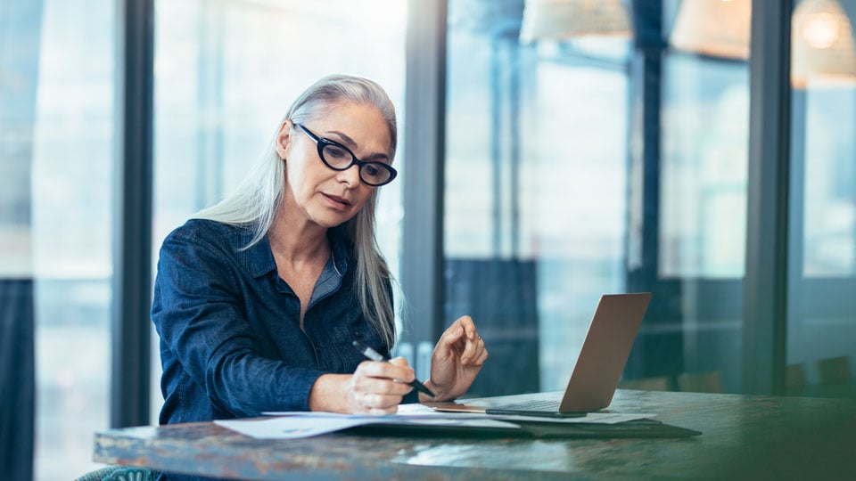 Tech worker looking at laptop