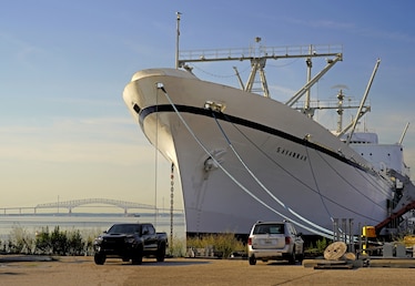 Photo of large white ship docked at harbor