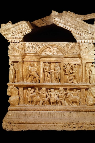 The labors of Hercules begin on the gable end of the Velletri sarcophagus, where an image of the deceased appears in the central panel surrounded by Hercules vignettes: The demigod wrestles with the Nemean lion and fights the many-headed hydra.