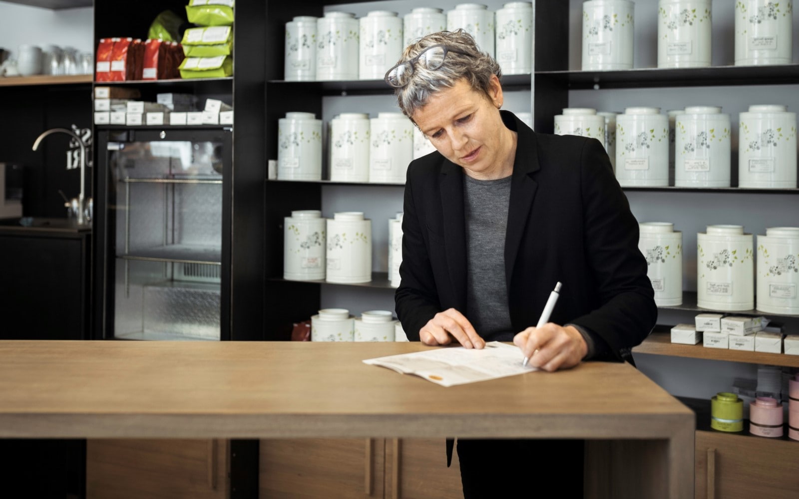 Female shop owner taking notes