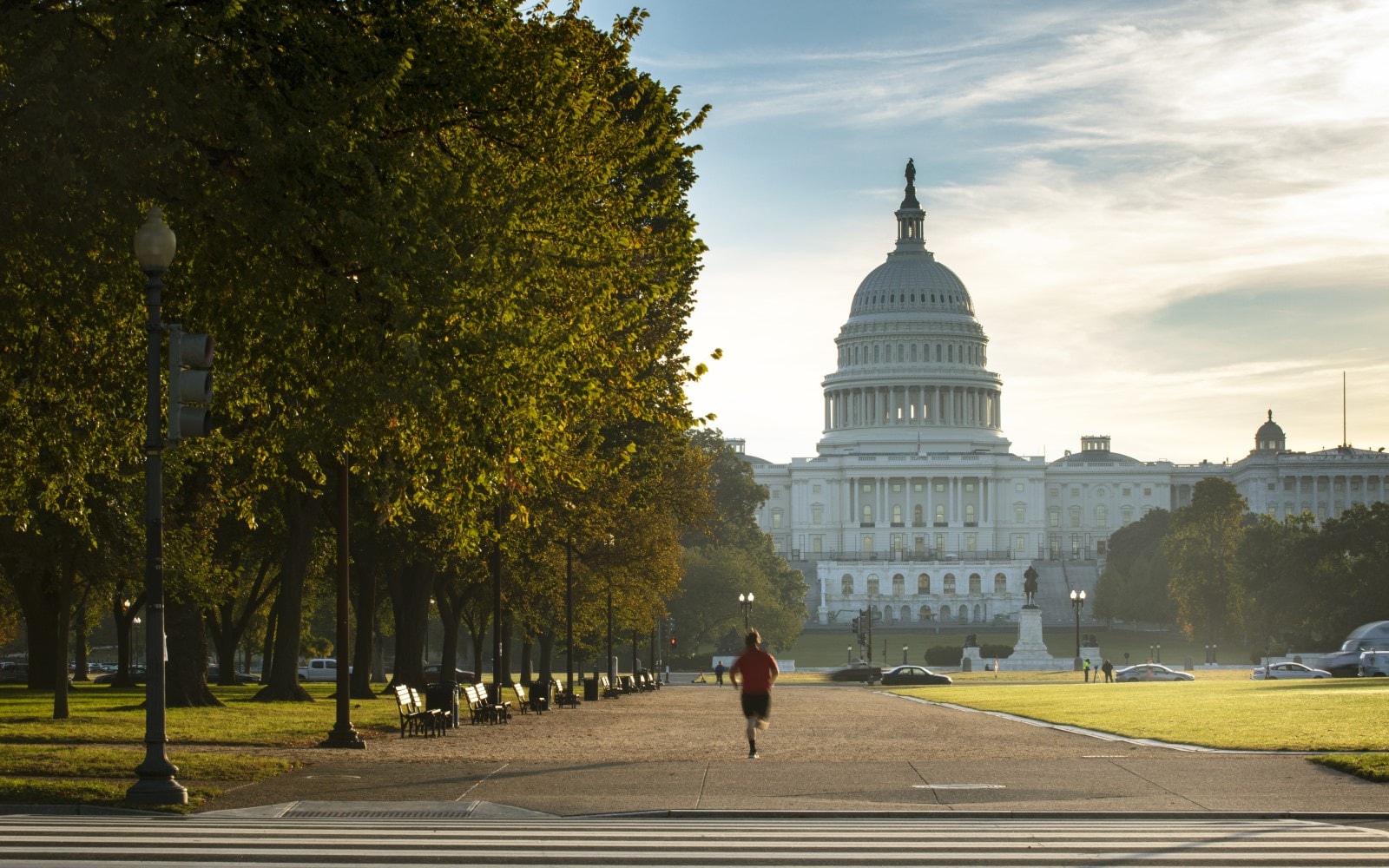 A man jogging in front of the United States Capital building