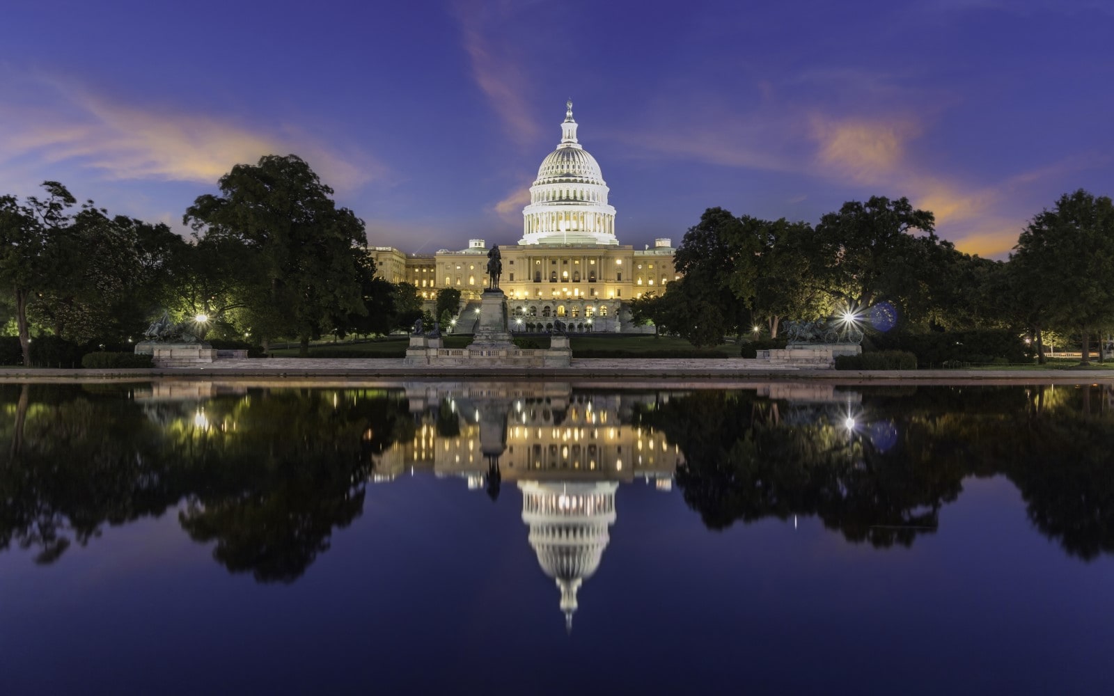 The United State Capitol at sunset with the reflection of the building in the Capitol Reflecting Pool