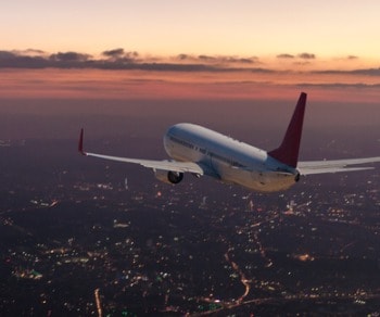 airplane flying at sunset