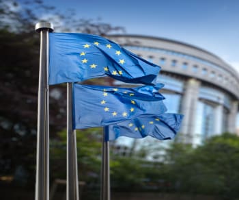 European union flag flying in front of building