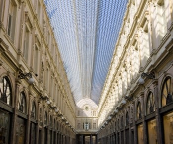 Inside architecture of columned building with glass ceiling