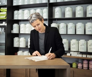 Female shop owner taking notes on paper