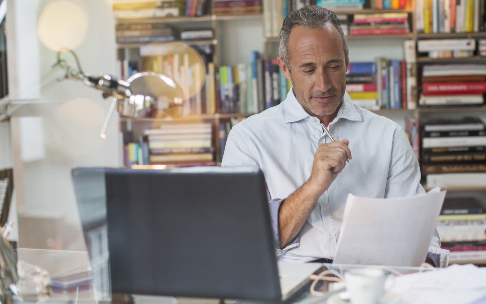 Woman using phone in home office