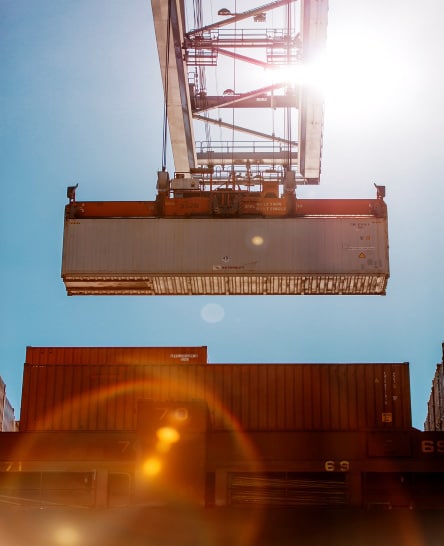 Ocean container being unloaded at port