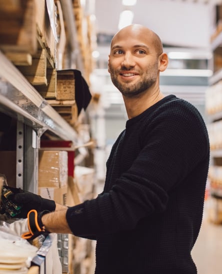 Warehouse worker picking spare parts for expedited fulfillment