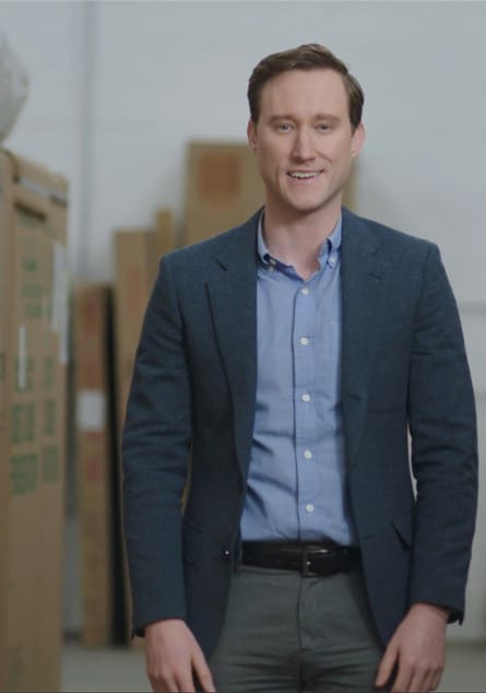 Man in warehouse standing in front of packages