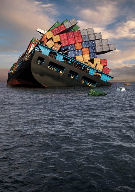 Shipping containers falling off listing ocean vessel.