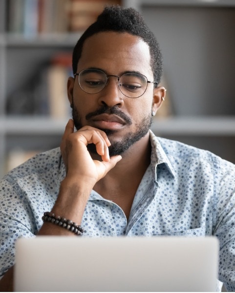 man-staring-at-computer in-serious-thought