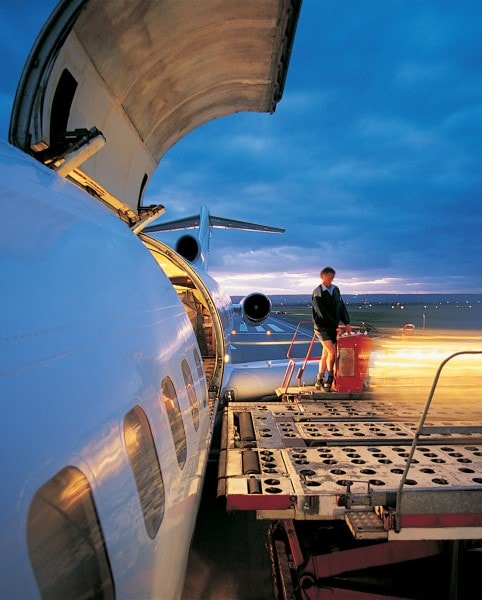 Handler loading freight on commercial air carrier