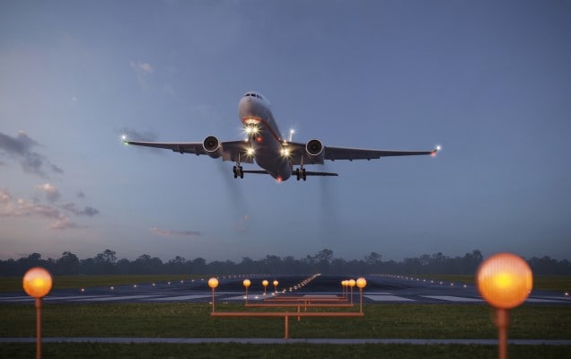 Airplane taking off from the airport runway at night