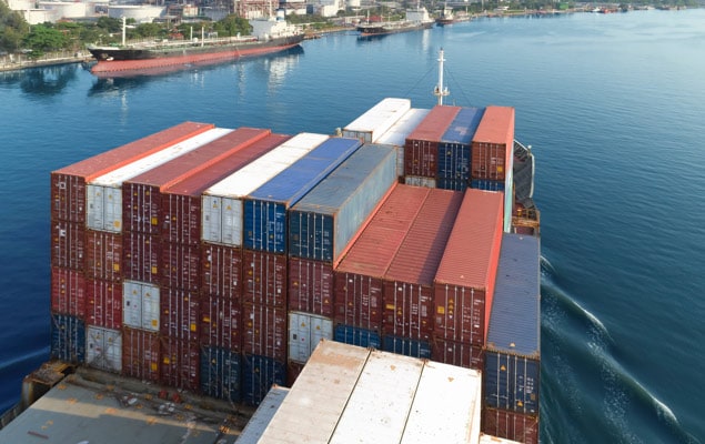 Ocean vessel full of containers arriving at port