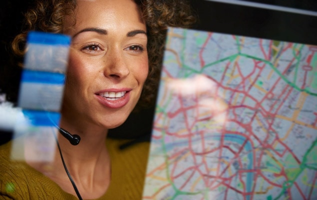 Woman in headset optimizing freight routes