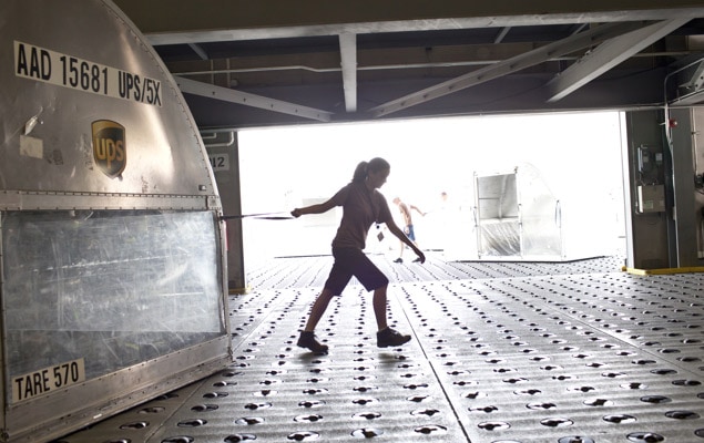 Woman pulling large eggshell airfreight container