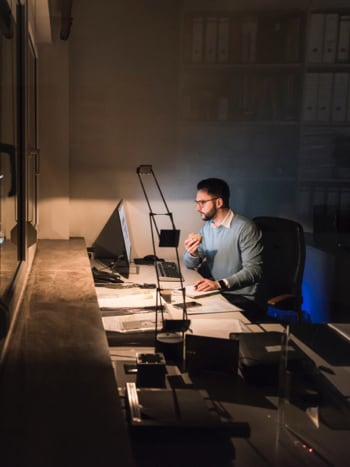 Transportation manager working late at night managing overseas suppliers