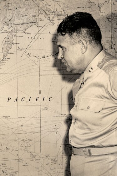 a man looking at a wall map of Japan and east Asia