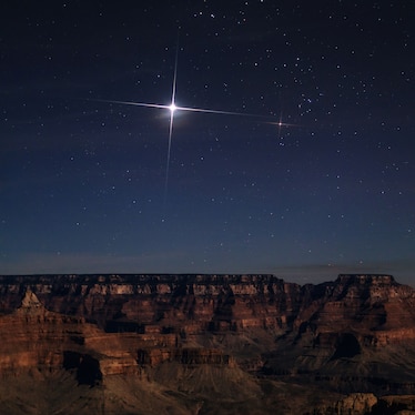 Jupiter over the Grand Canyon. On the right is bright red-orange star Aldebaran, in Taurus