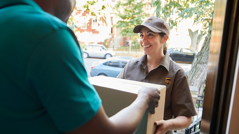 UPS driver picking up a package.