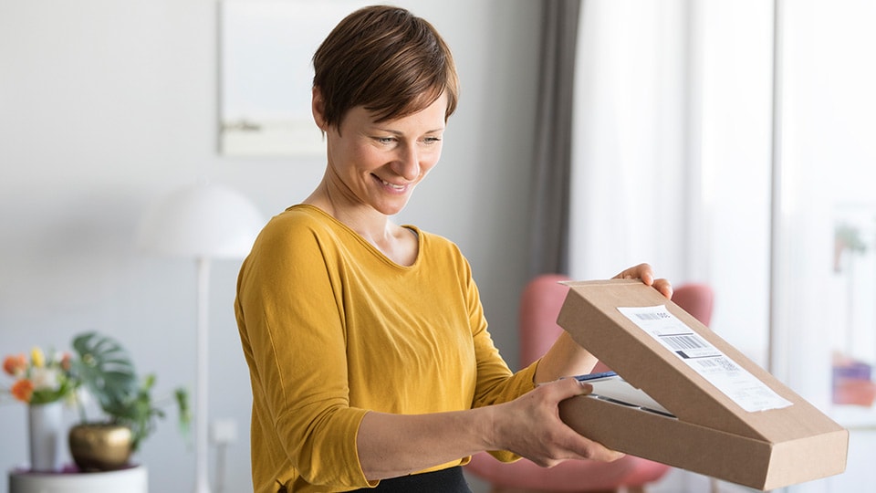 Woman opening a box