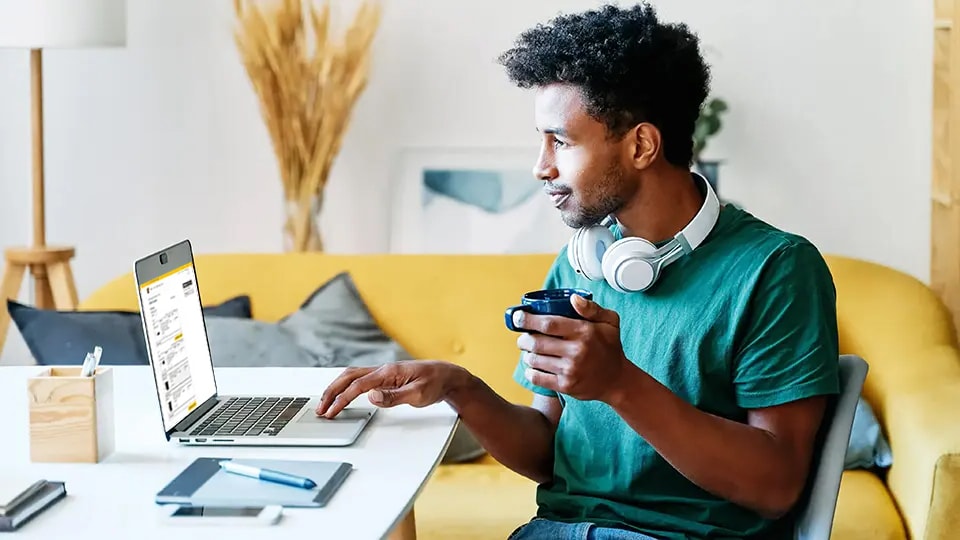 Man ordering UPS supplies on laptop