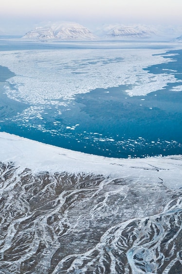 Picture of aerial view of Elveneset and the Bay of Sassenfjorden with white snow on blue ice.